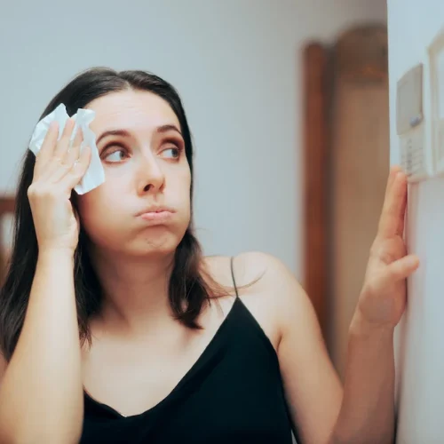 Women Checking Thermostat